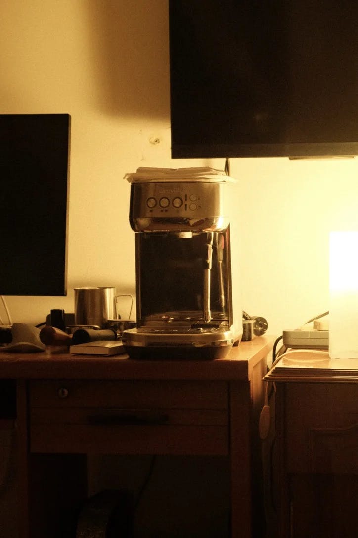 A photo of an espresso machine in warm light.