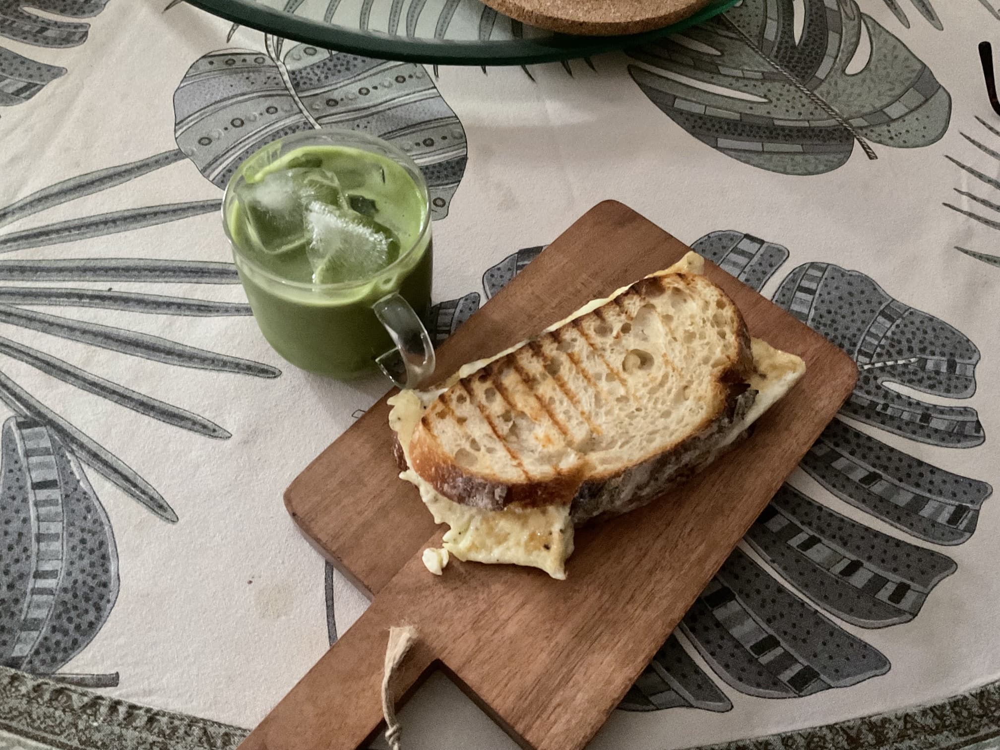 A breakfast plate with sourdough, egg, and a matte latte