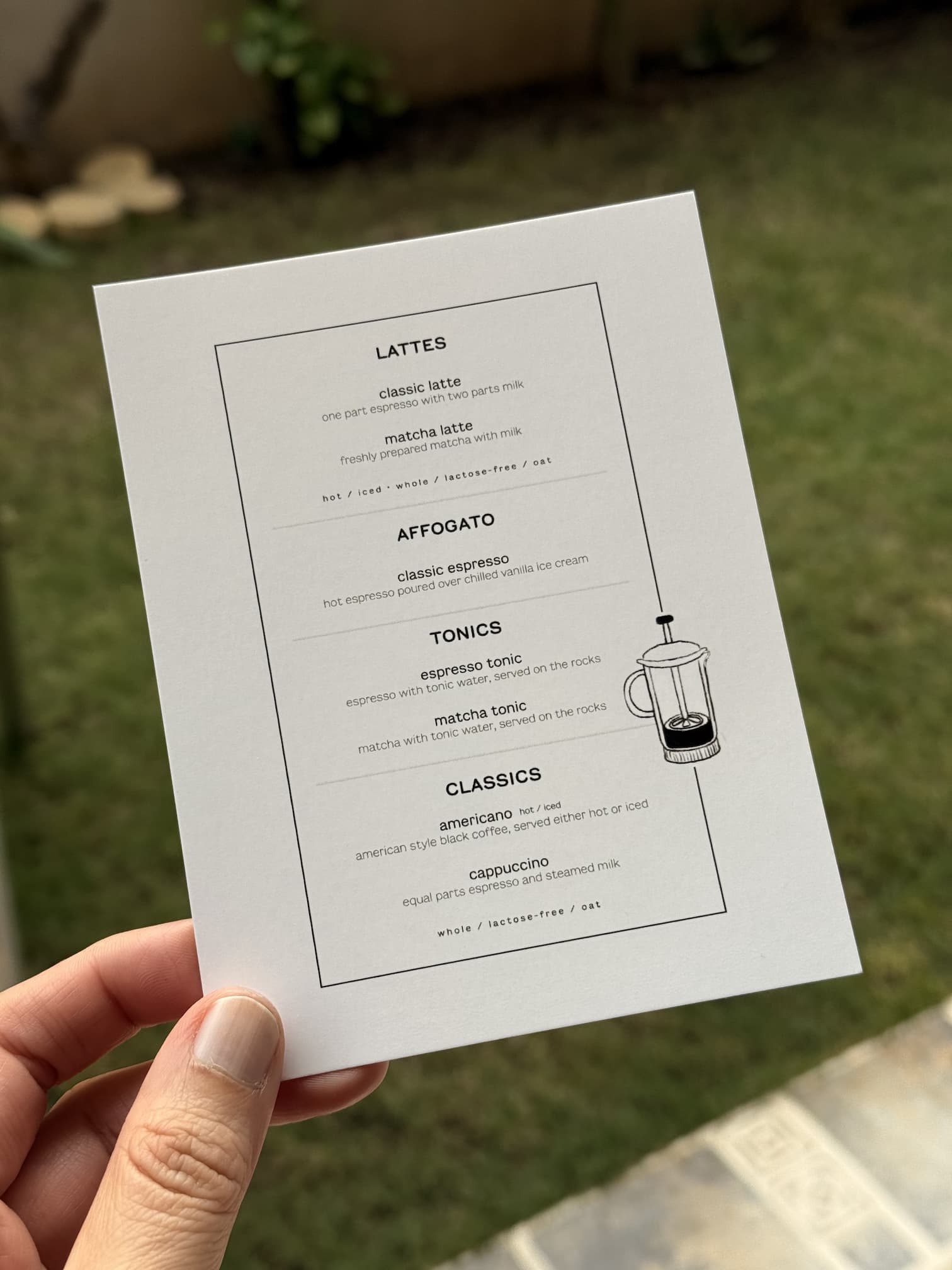 A home coffee bar menu with various coffee and matcha beverages listed