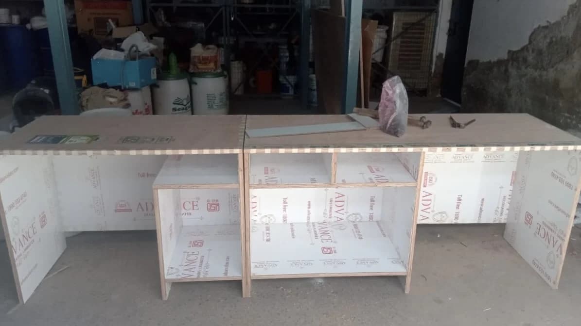 A work desk under contruction, being made in wood.